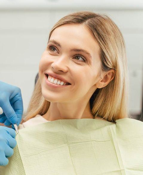 woman smiling at the beginning of her dental appointment