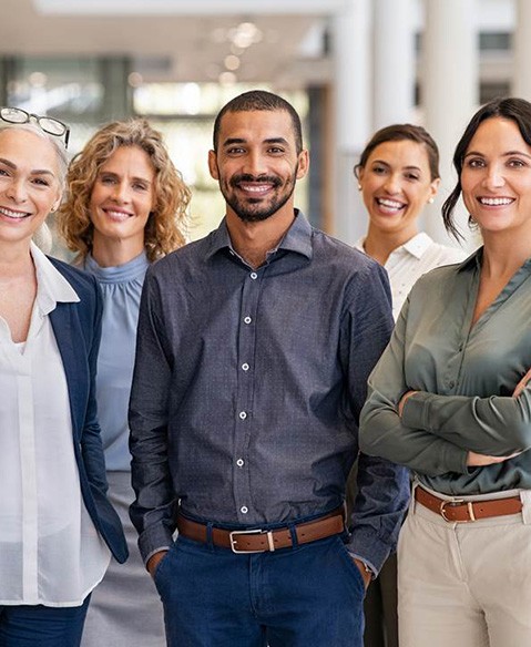 smiling group of co-workers in an office