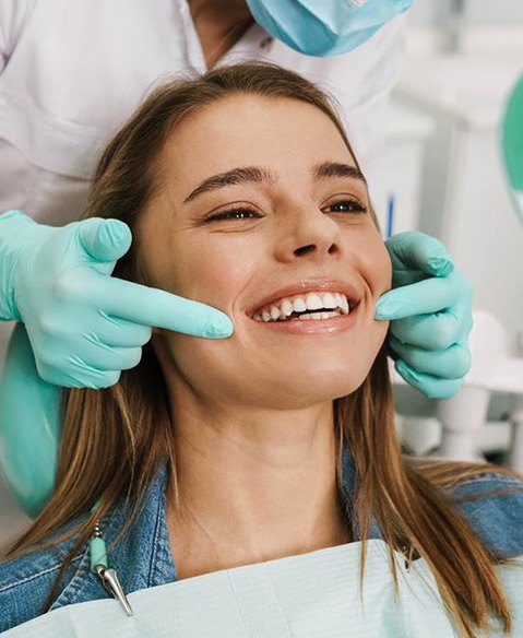 woman smiling in the dentist’s chair