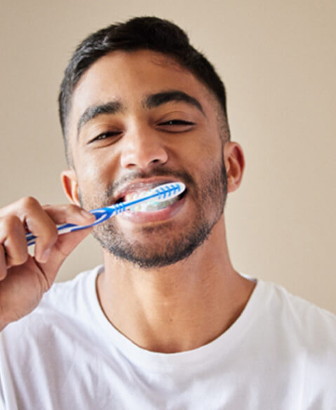 man brushing his teeth